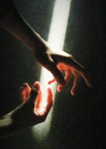 hands in shaft of light